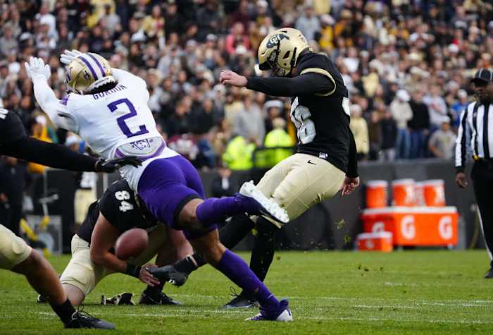 Nov 20, 2021; Boulder, Colorado, USA; Washington Huskies defensive back Kyler Gordon (2) dives as Colorado Buffaloes place kicker Cole Becker (36) kicks a field goal in the third quarter at Folsom Field. Mandatory Credit: Ron Chenoy-USA TODAY Sports